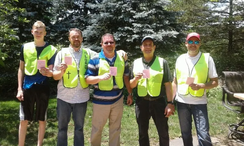 Men of the church in safety vests ready for a gospel tract outreach day