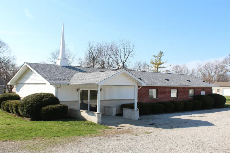 The white Christ Reformed Baptist Church building with its steeple on Woodward Avenue in New Castle